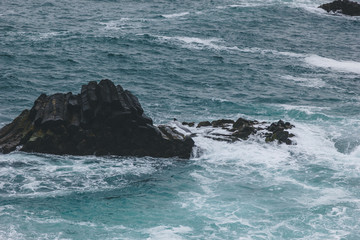 dramatic shot of ocean waves crashing on rocks for background