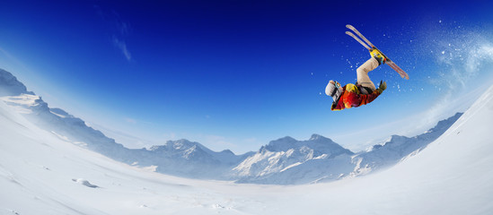Naklejka na ściany i meble Skiing. Jumping skier. Extreme winter sports.