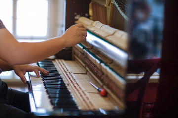 Piano repairers or musicians are repairing and customizing the piano.