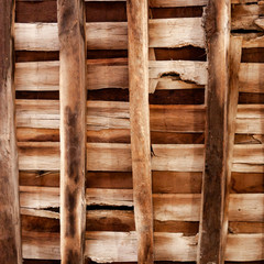 A square photo of crossed wooden boards