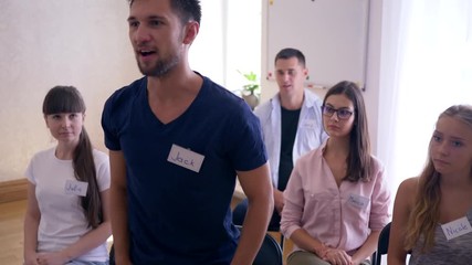 group teaching, successful happy businessman rejoices at achievements at training indoors