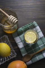 Honey and lemon on wooden background