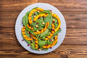 Autumn salad with pumpkin , spinach , pomegranate and chickpea