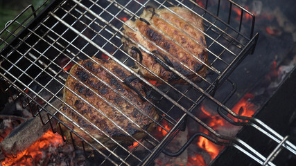 Barbecue with delicious grilled meat on the grill.Barbecue meat is fried grill grate.Grilled meats outdoors.Barbeque on the grill