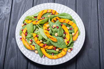 Autumn salad with pumpkin , spinach , pomegranate and chickpea