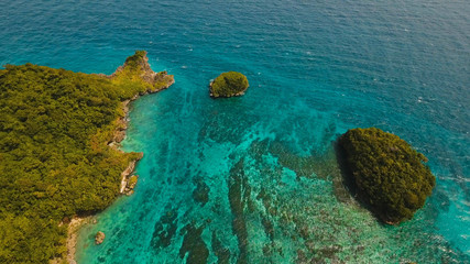 Aerial view of beautiful tropical island with with azure water,Boracay. Tropical lagoon with turquoise water. Beautiful tropical island. Seascape: Beautiful view of the island, rock in the sea from