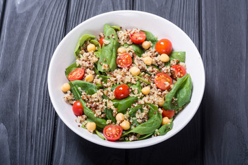 Spinach salad with quinoa , tomatoes and chickpea