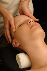 young woman receives skin massage treatment in spa salon