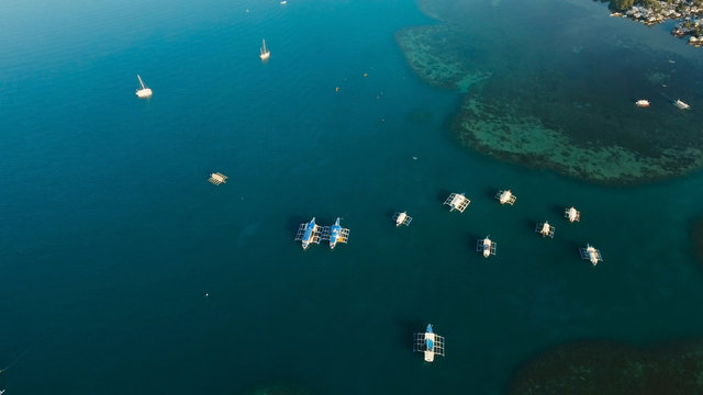 Fototapeta Aerial view of sailing boats and yachts in the bay. Boat and yacht in the tropical lagoon. Aerial view: tropical landscape. Tropical island. Philippines, El Nido. Travel concept