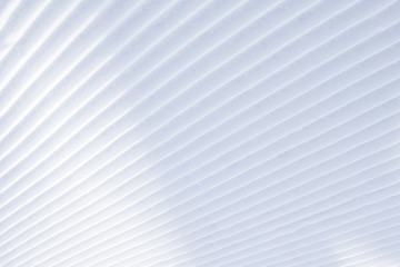 Diagonal parallel snow stripes background with light shadows