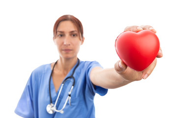 Woman cardiologist holding red heart shape.