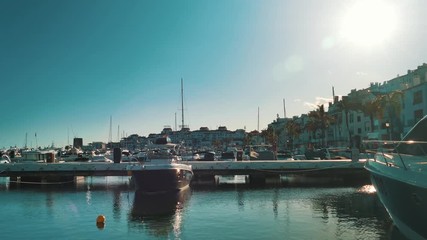 4K 25fps Tropical harbor full of yachts with palm trees. Marbella, Spain