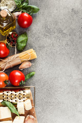 Food frame. Copy space. Food ingredients for Italian spaghetti on grey neutral background