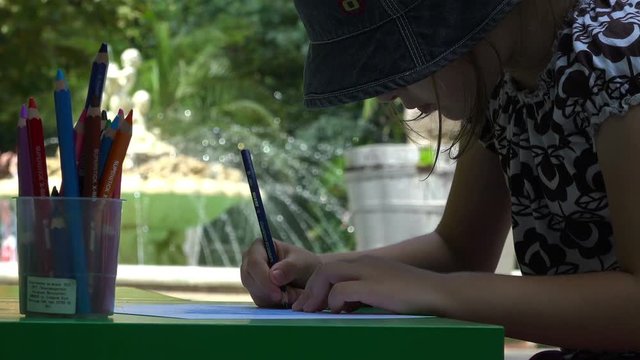 Silhouette of Little Girl Drawing outside