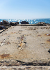 view from the stone pier to the sea and clear blue sky