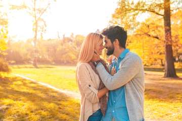 Fototapeta premium Portrait of happy young couple in love on sunny day in the park.