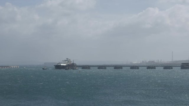 LNG tanker departs from jetty under strong wind