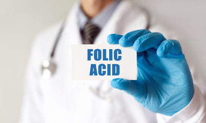 Doctor holding a card with text Folic Acid, Medical concept