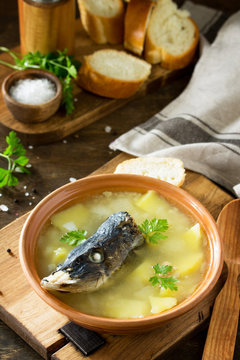 Fish soup from pike, with caviar on a wooden table in a rustic style. Traditional Russian cuisine.