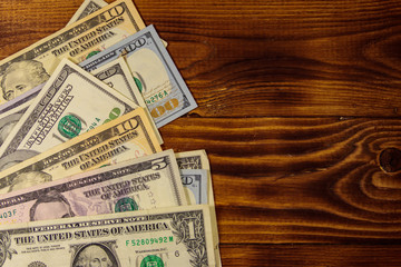 American dollars on wooden background. Top view, copy space