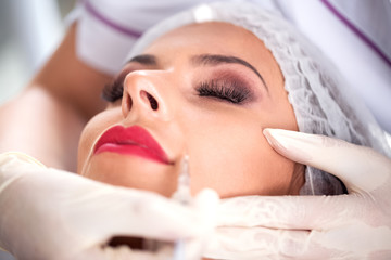 Attractive woman doing botox treatment