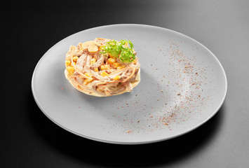 Salad with Chicken ham and corn carrots and Homemade Mayonnaise on black background for menu studio shot on grey plate