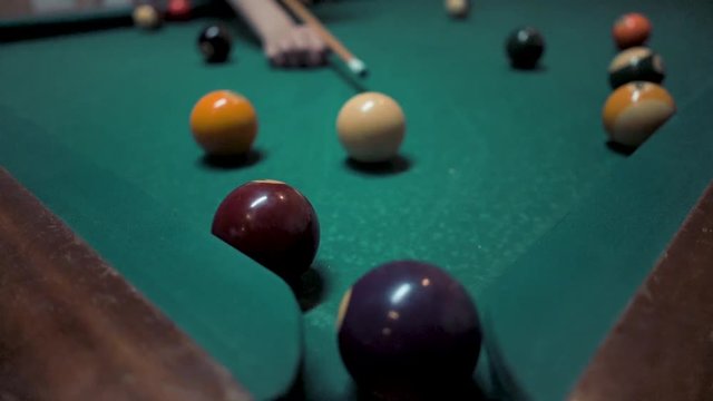 Pool billiard white ball hitting the purple four ball