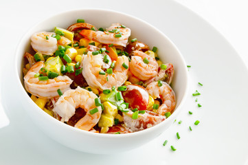 salad with steamed shrimps, cherry tomatoes, corn, and avocado dressed with mayonnaise and decorated with green onion
