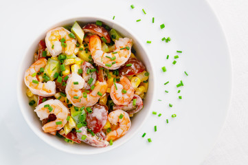 mayo based salad with steamed prawns, cherry tomatoes, corn, and avocado decorated with green onion
