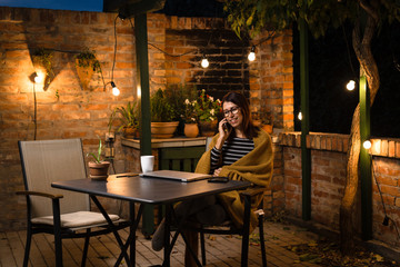 Woman using smart phone. Evening scene.