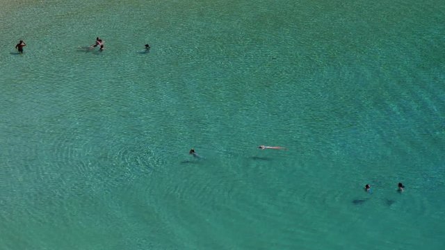 High view of swimmers enjoying the crystal clear water of Kedros beach in Donoussa island in Cyclades in Greece