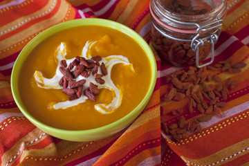 Homemade autumn pumpkin creamy soup on wooden table