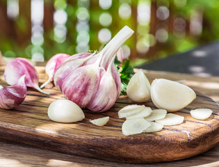 Garlic bulb and garlic cloves  on the wooden table.