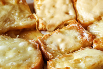 Freshly baked hot toasts with melted cheese close-up