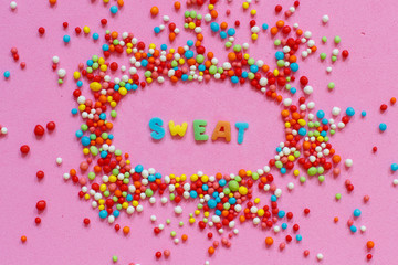 Colorful sugar sprinkles and a word Sweet