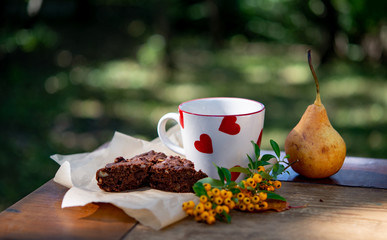 A cup of coffee and brownie cake with fall decoration