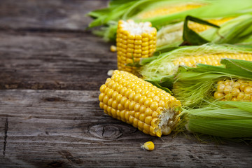 Ripe corn on a  wooden table.