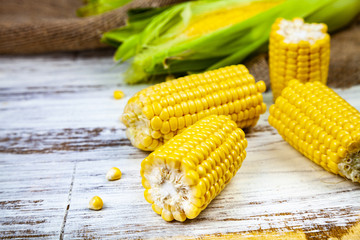 Ripe corn on a  wooden table.