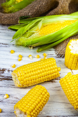 Ripe corn on a  wooden table.