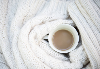 A cup of coffee with wool decoration