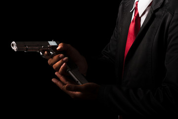 Close up Man changing gun magazines on black background.