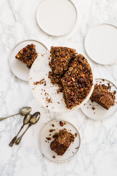 Homemade gluten free, vegetarian сarrot, banana and nuts Cake on white marble background