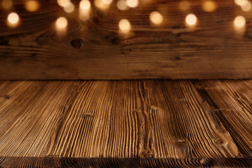 Wooden background with golden bokeh