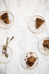 Homemade gluten free, vegetarian сarrot, banana and nuts Cake on white marble background