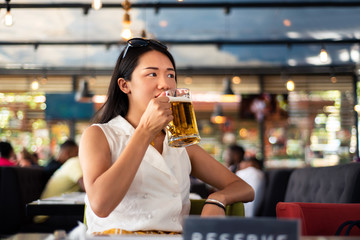 Girl having a beer in the bar