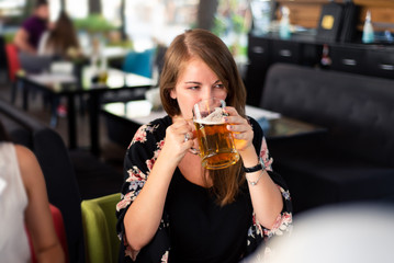 Girl having a beer in the bar