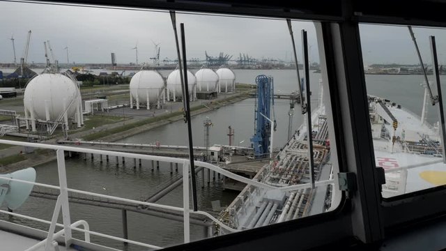 LPG tanker alongside gas holder in port