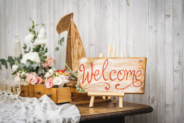 Wooden hand-written welcome sign. Rustic style