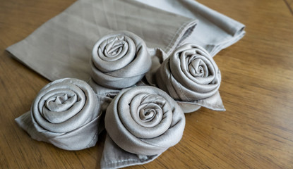 Preparing Golden napkin roses for decoration table events holidays and party white isolated background