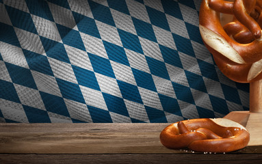 Empty Wood Board Table with Pretzel Decoration and Bavarian Background